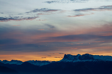 Uriage les Bains, Isère, Rhône-Alpes, France, 27 11 2022 magnificent sunset over the snowy mountains, blue yellow pink purple sky, cold colors sky