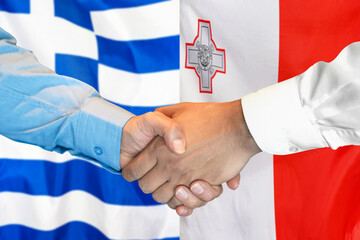 Business handshake on background of two flags. Men handshake on background of Greece flag and flag of Malta. Support concept