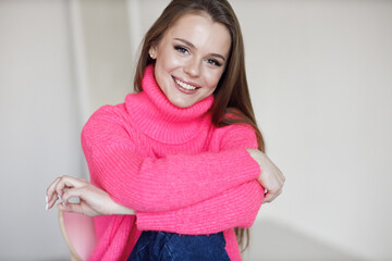 Young smiling woman indoors in cozy wear  - 552842450