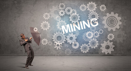 Obraz premium Businessman defending with umbrella concept