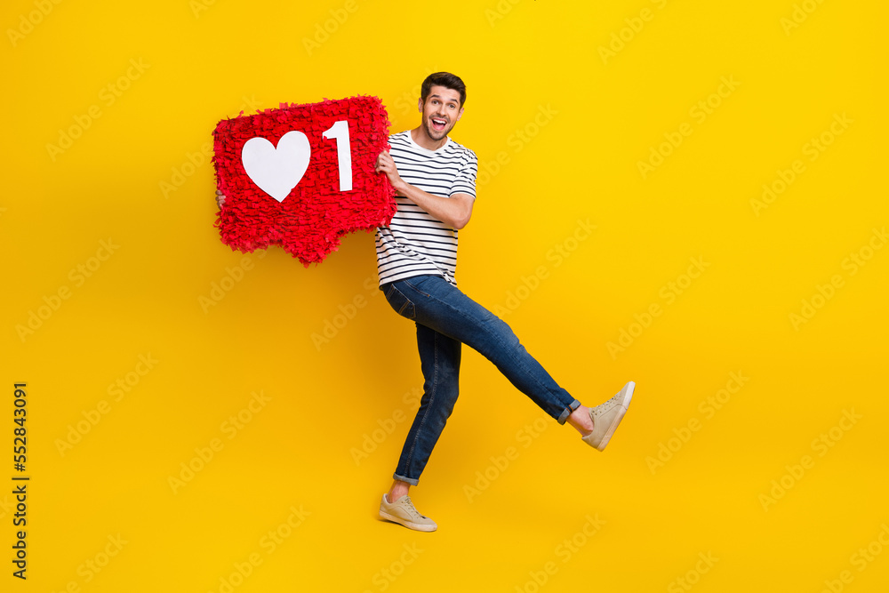 Sticker Full length photo of funky carefree man wear white t-shirt dancing having fun holding like pinata isolated yellow color background