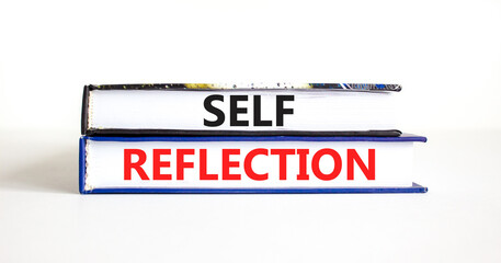 Self reflection symbol. Concept word Self reflection typed on books. Beautiful white table white background. Business psychological and self reflection concept. Copy space.
