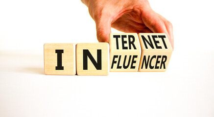 Internet influencer symbol. Concept word Internet influencer on wooden cubes. Beautiful white table white background. Businessman hand. Business internet influencer concept. Copy space.