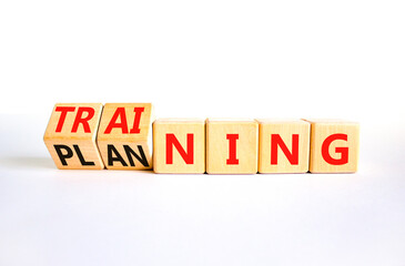 Training and planning symbol. Concept word Training and Planning on wooden cubes. Beautiful white table white background. Business training and planning concept. Copy space.