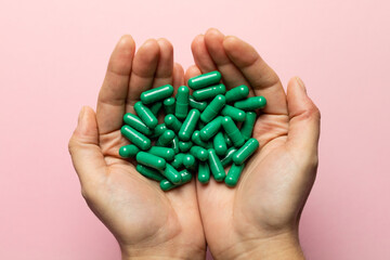 Rhodiola rosea capsules held in hands. Health and happy life concept.