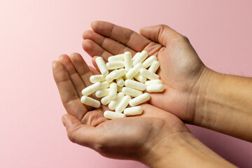 White zinc tablets in the hands. Care for health and life.