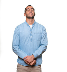 Tired young man posing against background