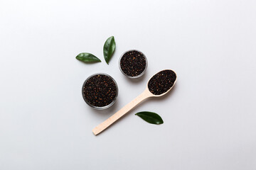 quinoa seeds in bowl and spoon on colored background. Healthy kinwa in small bowl. Healthy superfood