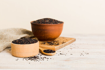 quinoa seeds in bowl and spoon on colored background. Healthy kinwa in small bowl. Healthy superfood