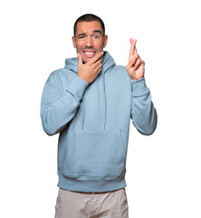 Concerned young man doing a crossed fingers gesture