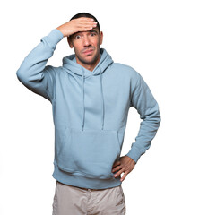 Depressed young man posing against background