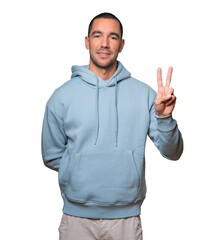 Fototapeta premium Young man making a number two gesture