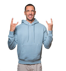 Fototapeta premium Naughty young man making a rock gesture