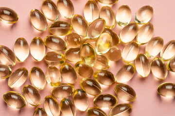 D3 K2 capsules on a pink background. Healthy life concept.