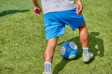 Latino youth playing soccer on a synthetic field © oaxe