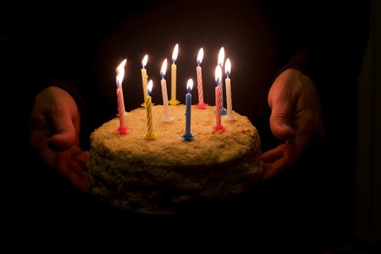 Cake with lighted birthday candles.