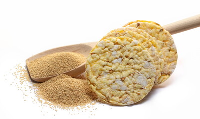 Corn cakes with amaranth seeds in wooden spoon isolated on white