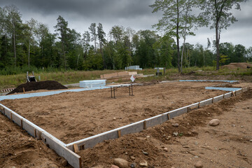 New home construction job site with wood forms in place for concrete cement to be poured for the...