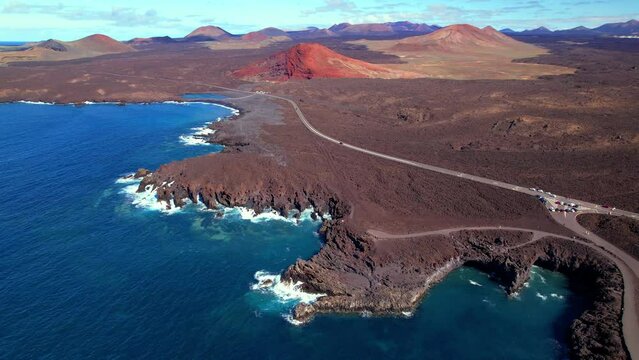 Volcanic Lanzarote island scenery. aerial drone video of Los Hervideros caves and cliffs and Red mountain . popular tourist destination  Canary islands