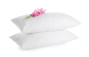 Fototapeta na wymiar Soft pillows with beautiful flowers on white background