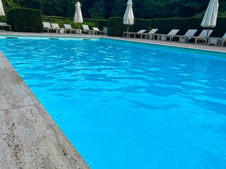 Outdoor swimming pool in luxury hotel on sunny summer day. Time for relax
