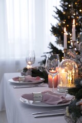 Beautiful festive table setting with Christmas decor in room, space for text
