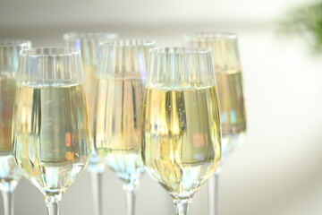Glasses of champagne on blurred background, closeup view
