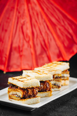 good sangwich with fried meat on a plate in the restaurant 