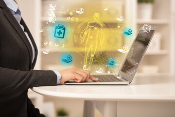 Doctor working on laptop with healthcare concept