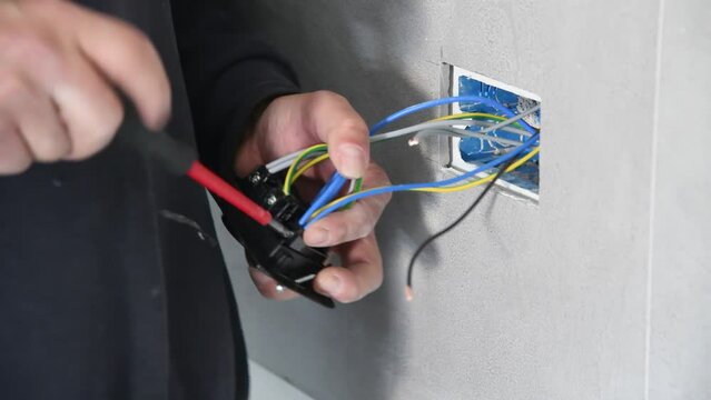 Electrician working on switches and sockets of a residential electrical system