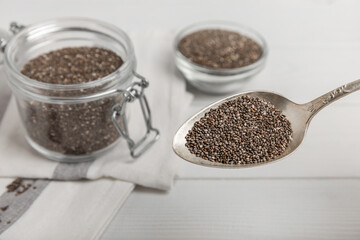 Chia in a spoon and a glass jar close-up.Superfood. Healthy food. Diet. The concept of proper nutrition. antioxidant. Place for text, space for copy.