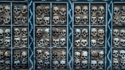 Full Frame Shot Of Human Skull And Bones Mounted On Wall At Tibet, China - Powered by Adobe