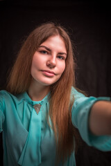 Portrait of a young beautiful girl with long hair in the studio.