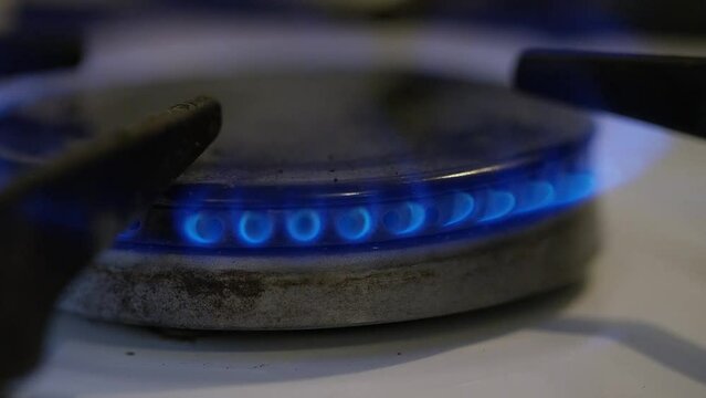 Close shot of gas stove fire being turned on and heat being increased and decreased