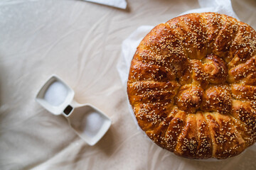 A close up of slava bread held by grandma at the village 
