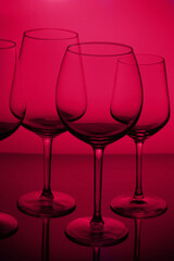 Row of wine glasses on viva magenta background