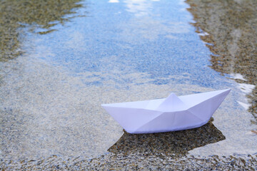 Beautiful white paper boat on water outdoors, space for text
