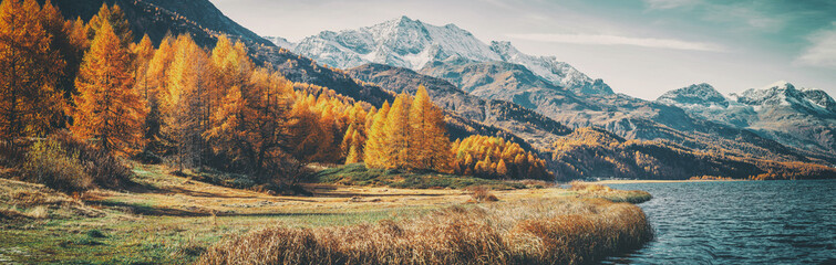 Amazing natural autumn scenery.  Panoramic view of beautiful mountain landscape in Alps with Lake...