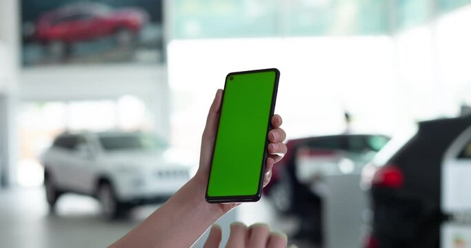 hand holding tablet pc with screen in auto showroom