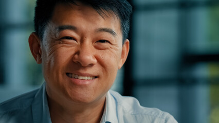 Happy smiling korean japanese confident 40s man successful businessman worker specialist agent businessperson banker leadership representative joyful positive male asian portrait in business office