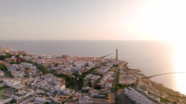 Sky view of the beautiful city Chipiona flying a drone, in the province of Cadiz (Andalucia, Spain). In the shot is shown Chipiona's lighthouse at the coast, and typical andalusian small white houses.