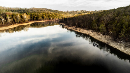 Fishermen fishing out of bass boat in the winter on table rock lake in missouri