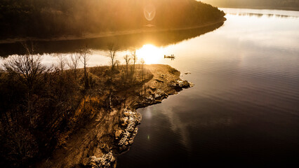 Bass fisherman fishing on table rock lake in missouri during sunrise in the winter