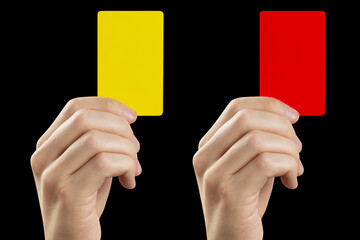 Referee hand holding yellow and red cards, isolated on black background