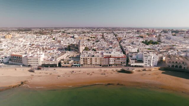 Sky view of the beautiful city Chipiona flying a drone, in the province of Cadiz (Andalucia, Spain). In the shot is shown the typical andalusian small white houses from the beach.