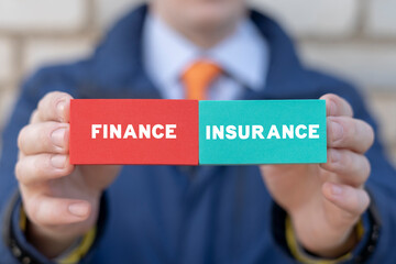 Bank employee holding styrofoam colorful blocks with inscription: FINANCE INSURANCE. Concept of finance insurance and money protection. Financial insurance.