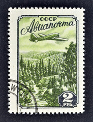  Cancelled postage stamp printed by Soviet Union, that shows Aircraft Over Taiga, circa 1965.