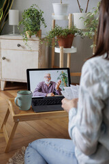 video chat woman communicates with man via video communication from laptop and makes notes, training webinar, friendly communication. online consultation, home office, modern technologies
