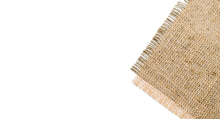 Corner of burlap on a white background. Rough fabric texture. Empty space on the left.