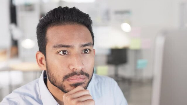 Business man analyzing project strategy on a computer screen while working in an office. Closeup of focused young professional thinking of solutions while carefully reading ideas and plans online